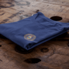 t-shirt-mockup-of-a-folded-t-shirt-over-a-wooden-surface-6485a